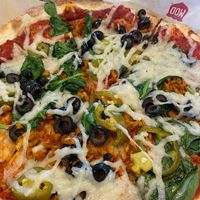 Pizza with black olives, spinach, jalapenos, non-dairy cheese and faux sausage  at Mod Pizza - Harden Ranch in Salinas