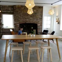 Pale wood furniture with open fireplace at Bean and Bread in Abergavenny