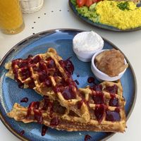 Sugar free waffles, with berry sauce - customised here with coconut cream and stewed apples  at Cakester Cafe in Krakow
