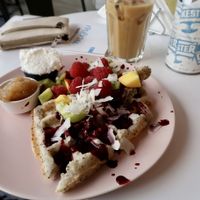 Vegan chia waffles with coconut cream and fruit at Cakester Cafe in Krakow