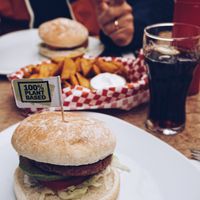 The burger has been served on a plain white plate. at Oilers69 in Haiming