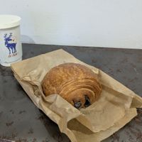 Pain au chocolat and latte in all-paper to-go cup. ❤️ at Oh Faon in Marseille