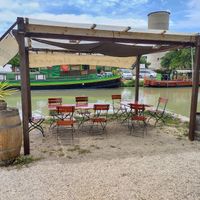 Outside seating right on the canal du midi at Le Comptoir Nature in Le Somail