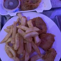 Curry sauce & pea bomb at top. Chips with 1 battered tofu, half a battered sausage and half a fish    at Capplemans Fish and Chips in Scarborough