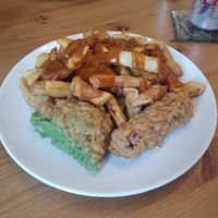 Chips, curry sauce, sausage and mushy pea bomb at Capplemans Fish and Chips in Scarborough