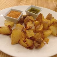 Patatas bravas with mojo verde and romesco sauces at Raices in Pamplona