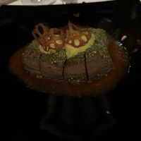 Sliced aubergine in pistachio crust on red pepper cream with saffron mousse and lotus root chips  at Ad Forum in Aosta