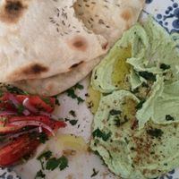Seasonal dish: fava beans hummus with homemade bread and a salad. at Klubojadalnia Młodsza Siostra in Warsaw