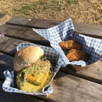Cali green breakfast sandwich (£9.50) with sausage patty, melted cheese, tofu egg, sprouts and smashed avocado and hash browns (free).  at Vausages in Lichfield
