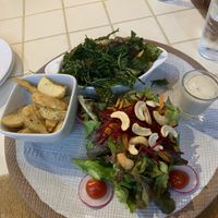 Basil stir fry, chips and salad at Ohkajhu Organic Restaurant in Bangkok