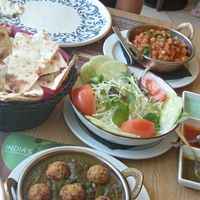 Vegan koftas in spinach curry with mixed salad at Taste Of India in Riva Del Garda