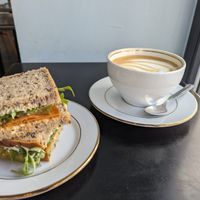 Vegan pepperoni and oat milk latte at STOR in Warsaw