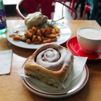 Cinnamon roll, seitan biscuits and gravy, and potatoes. Spicy chai on the side.  at Sweetpea Baking Company in Portland