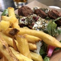 Falafel bowl with hummus, fries & some  at Paralela in Prague
