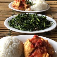 Tofu in tomato sauce and morning glory sautéed with garlic at Quan 3 Chi Em in Mai Chau