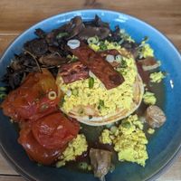 Pancakes with tofu and this isn't bacon. Added tomatoes and mushrooms at The Old Gun Shop Café & Pantry in Lancaster