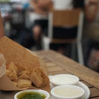 Bread and sauces for free: tahini and cilantro (sour cream is not vegan) at Miznon in Vienna