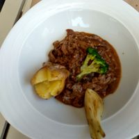 Ragout of seitan and mushrooms served to a potatoes, onion, and broccoli.  at Sa Garrofa in Begur