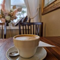 Cappuccino with soy milk, view to the courtyard. at Café Engel in Helsinki