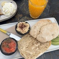 Sandwich with tomato, handmade hummus and avocado + orange juice   at Almazen Cafe in Sevilla