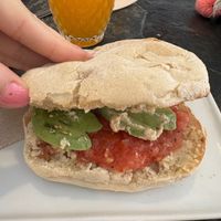 Sandwich with tomato, handmade hummus and avocado + orange juicee  at Almazen Cafe in Sevilla