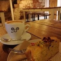 Oat milk latte and lemon & poppy seed cake (one of 7 vegan cakes available) at Jaunty Goat - Bridge St in Chester