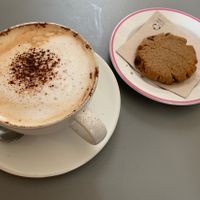 Cappuccino with almond milk and homemade cookie at Umami Good Food in Tenerife