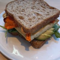 Vegan breakfast sandwich. Tofu bacon carrot thingy. Yummy sauce. I added the avocado for $3    at LB Kitchen in Portland