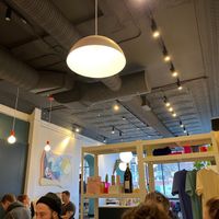 Indoor seating area, art, and items for sale at LB Kitchen in Portland