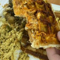 Sausage pizza stuffed waffle, scramble and potatoes on the side at The Greener Kitchen in Baltimore
