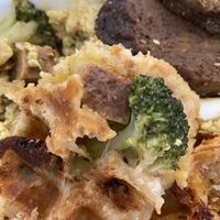 Ham and cheese stuffed waffle with scramble and sausage on the side  at The Greener Kitchen in Baltimore