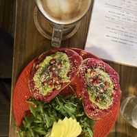 Flat white with coconut and beetroot hummus avocado toast  at Panenská Kaviareň in Bratislava