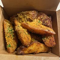 Garlic parmigiano potato wedges  at Pura Vita in West Hollywood