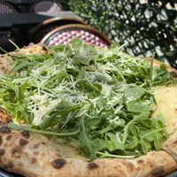 Amelia white pizza with cashew cream  macadam parm and arugula   at Pura Vita in West Hollywood