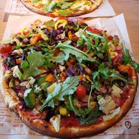 Vegan build your own in foreground. Hubby's meat pie in background. at Blaze Pizza in Amherst