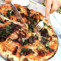 Padana pizza with vegan cheese, tomato sauce, caramelized onions, spinach, red onions & garlic oil. at Pizza Express in Paphos