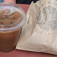 Cold brew coffee with oat milk. Apple fritter in the bag. at Rise Authentic Baking Co in Grand Rapids