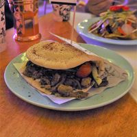 Shawarma [£9.50] – Seitan Doner, Persian Salad, Green Tahini Sauce, Pickles, Garlic Sauce & Chili Sauce in Pita at Genesis Plant Based Alchemy in North London