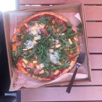Pizza with vegan cheese, pineapple, jalapeño, arugula, spinach, and onions.  at Blaze Pizza in Midlothian