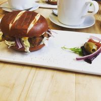 Tofu “chicken” burger on a pretzel bun  at Pepino Deli in Glossop