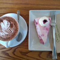 Hot choc (oat milk available) and homemade lemon and blueberry cheesecake at The Bakehouse Cafe in Forres