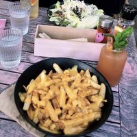 Poutine (and caesar salad in background)! Front drink is the kombucha cocktail and back one is plain kombucha  at Good Love in St Kilda