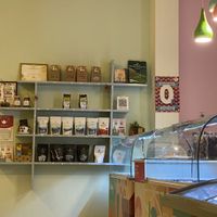 Tea shelf and packed ice cream freezers with half being vegan. (Still hoping for 100% Ⓥ in the future.)  at Gelato Factory in Auroville