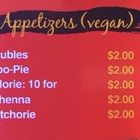 Labeled vegan appetizer selection at Singh's Roti Delight in Lauderdale Lakes
