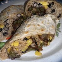 Veganized a quesadilla- ask for a rice and bean quesadilla with no cheese no sour cream. Add guac and peppers, corn, onions. Comes with sour cream too  at The International Delight Cafe in Bellmore