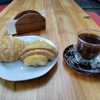 Mock cheese croissants and coffee. at Alma Natura in Medellin