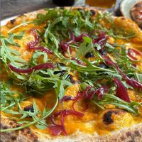 Pumpkin base, marinated onions, greens, olive oil  at Amuni in Bruges