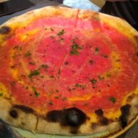 Vegan pizza with tomato, garlic and parsley at Amuni in Bruges