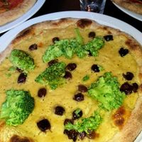 vegan pizza with chickpea cream, broccoli and olives at Amuni in Bruges