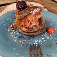 Pancakes with peanut butter, orange slices, and strawberries  at Peanut's Café in Sainte-maxime